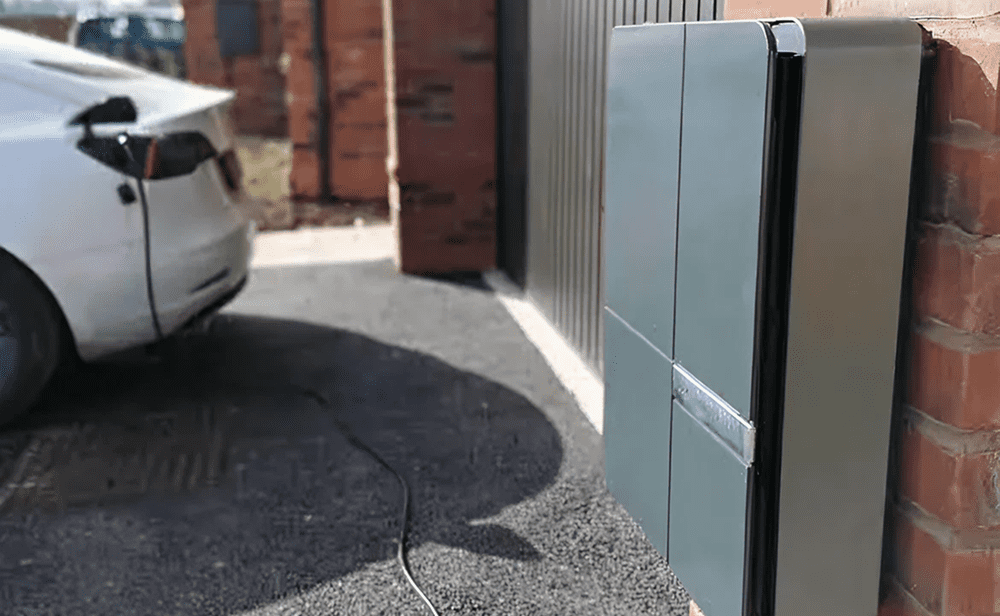 Electric vehicle charging station next to a parked car.