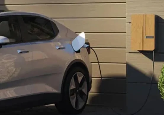 Electric car charging at home on a sunny day.
